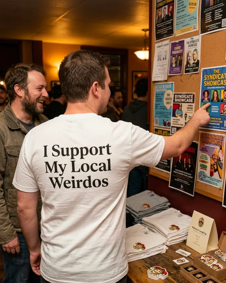 I Support My Local Weirdos white comedy shirt worn at a local comedy merch table