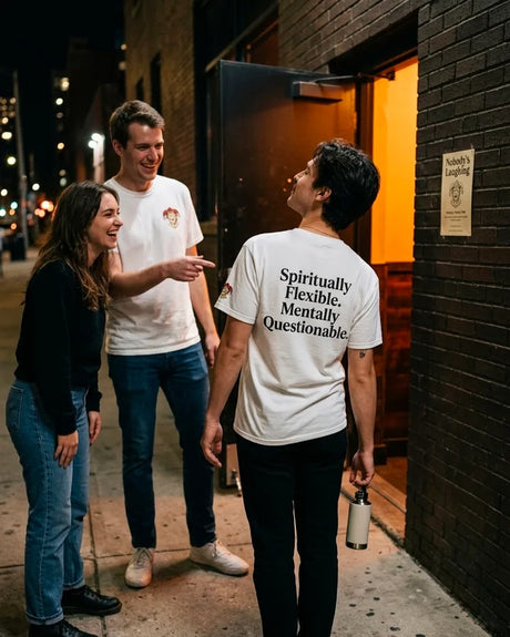 Spiritually Flexible Mentally Questionable white funny shirt worn outside a comedy venue with friends laughing