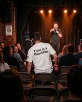 Time Is a Punchline white comedy shirt worn while entering a live comedy room